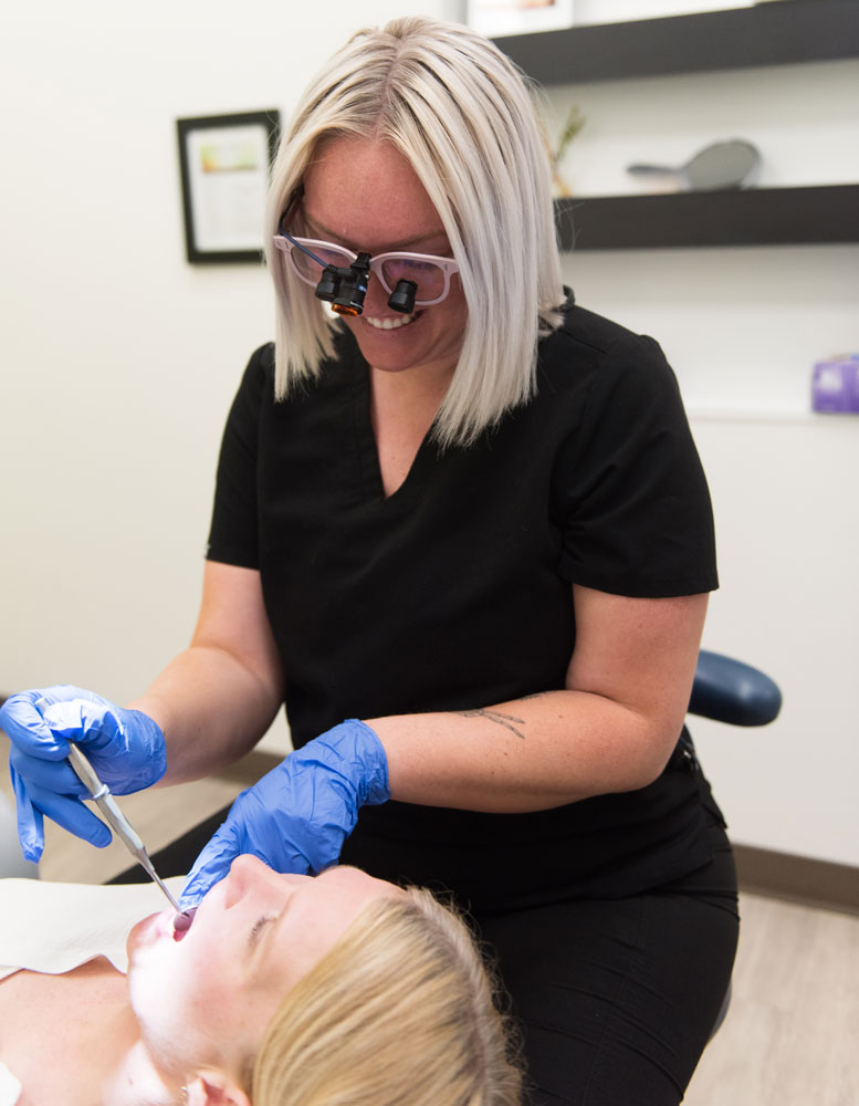 hygienist checking patients teeth