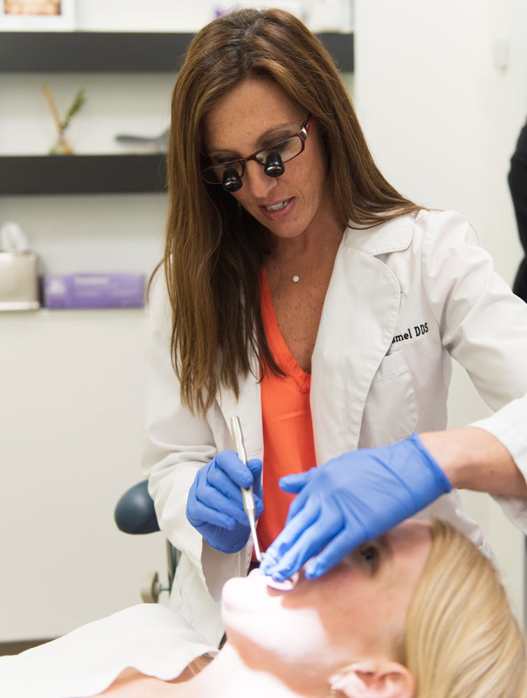 dr kassmel checking patients teeth