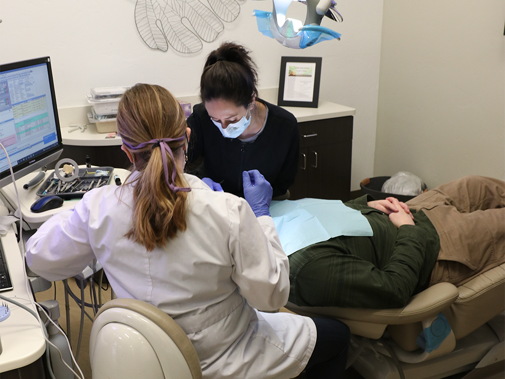 dr albers and hygienist working on patients teeth