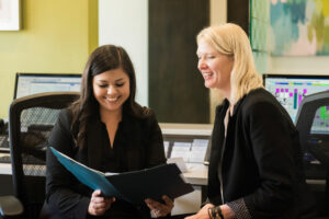 two girls smiling at forms