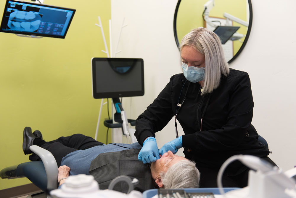 hygienist checking patients teeth